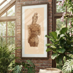 The Many Faced Woman artwork displayed in a sun-drenched conservatory. The print is mounted on an exposed brick wall surrounded by lush indoor plants, highlighting how the organic textures of the art blend with botanical and rustic interiors.
